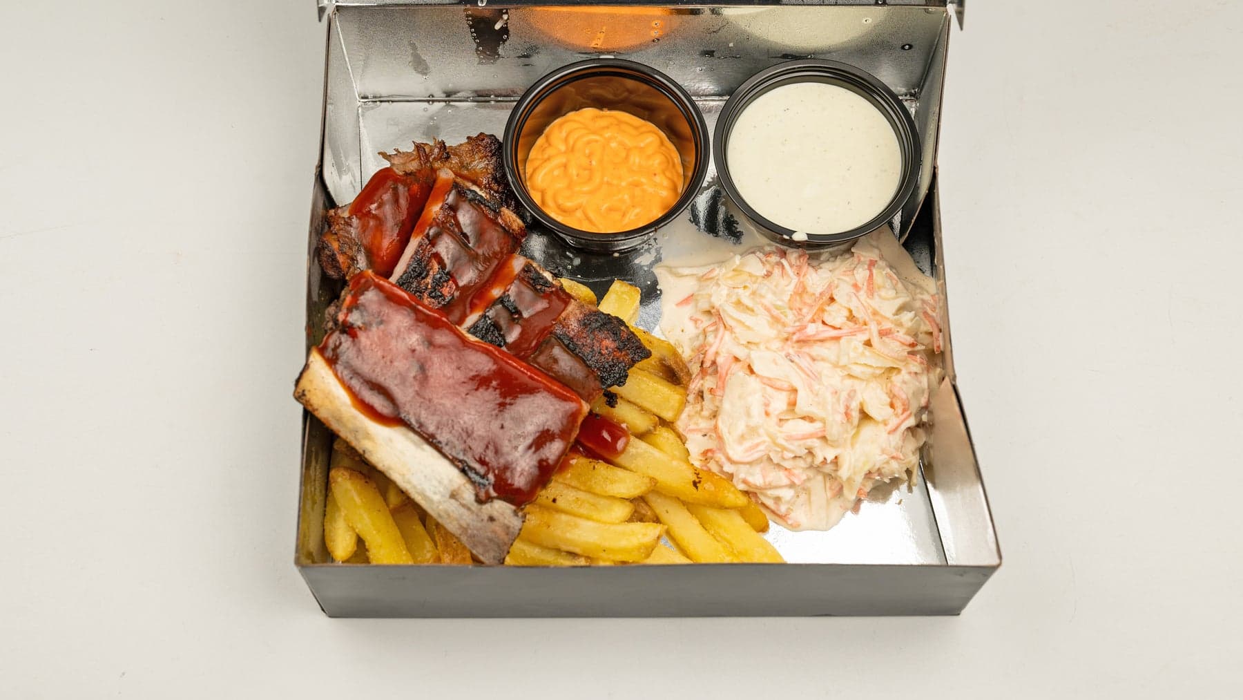 Half rack of glazed smoked pork ribs served with fries, coleslaw and house sauces